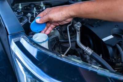 Cropped image of mechanic repairing car