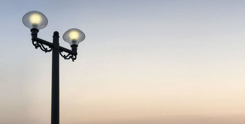 Low angle view of street light against sky