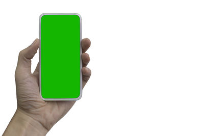 Close-up of hand holding smart phone over white background
