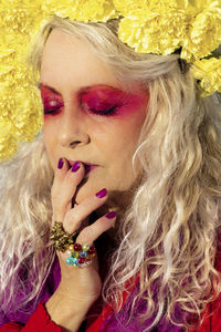 Close-up portrait of woman with pink flower