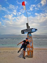 People on beach against sky