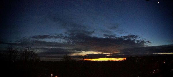 Silhouette landscape against dramatic sky during sunset