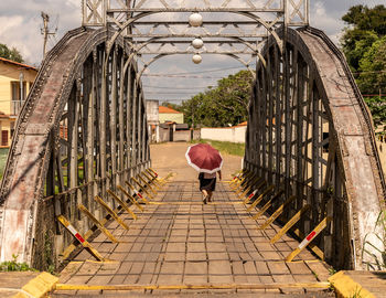 Rear view of woman walking on footpath