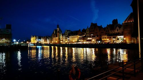 Illuminated cityscape against sky at night