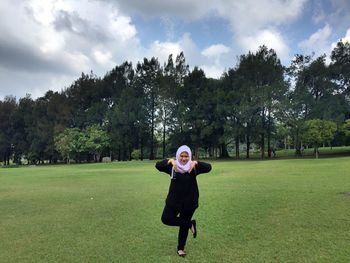 Full length of woman in park against sky