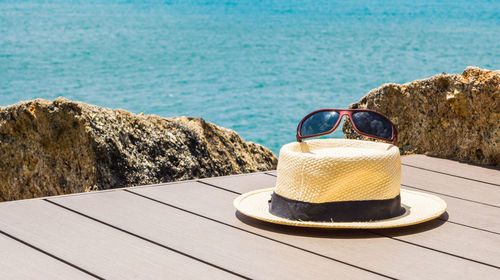 Close-up of hat on rock by sea