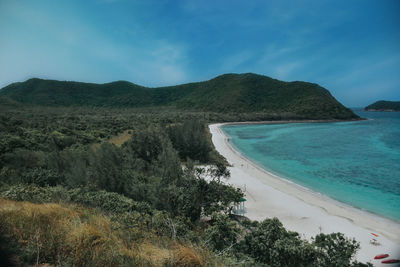 Scenic view of sea and mountains against sky