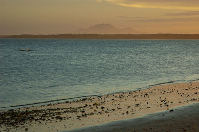 Scenic view of beach against sky during sunset