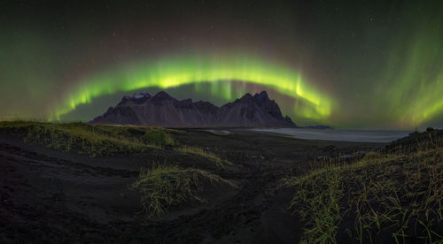 Scenic view of snowcapped mountains against sky at night