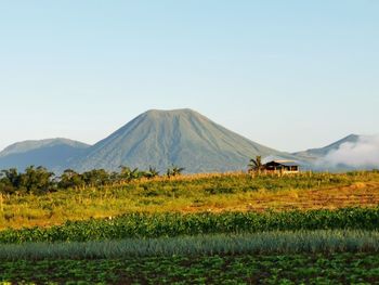 Scenic view of land and mountains against sky