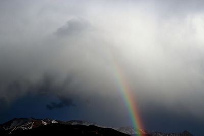 Rainbow over mountain against sky