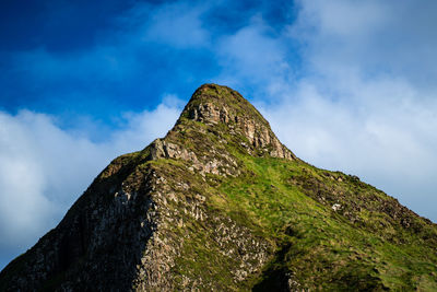 Low angle view of rock formation against sky