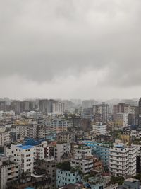 Cityscape against cloudy sky