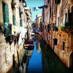 Boats in canal along buildings