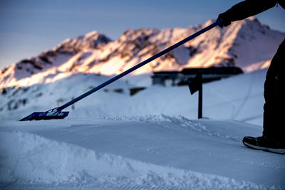 Person on snow against sky during sunset