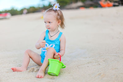 Cute girl sitting on beach