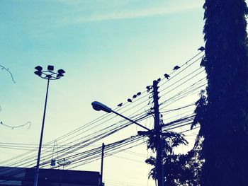 Low angle view of electricity pylon against sky