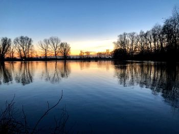 Scenic view of lake against sky during sunset