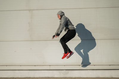 Low section of woman walking on wall