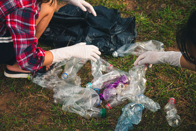 High angle view of man holding garbage in grass
