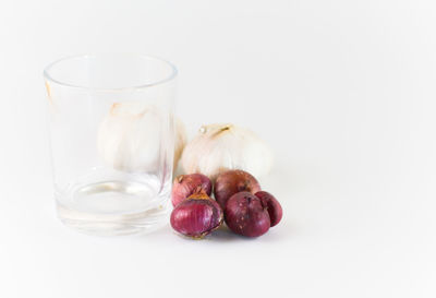 Close-up of fruits in plate against white background