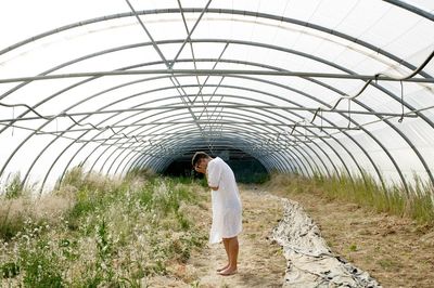 Woman standing by plants