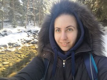 Portrait of smiling young woman in snow