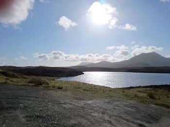 Scenic view of lake against cloudy sky