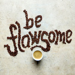 Directly above shot of coffee bean text on stone table 