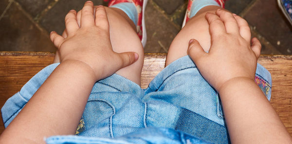 Midsection of baby sitting on bench