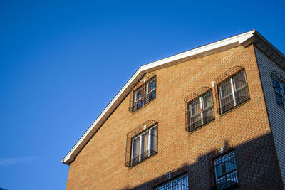 Low angle view of building against clear blue sky