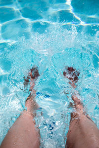 Low section of women in swimming pool