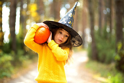 Cute girl wearing hat standing outdoors