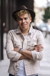 Portrait of young man wearing hat standing outdoors