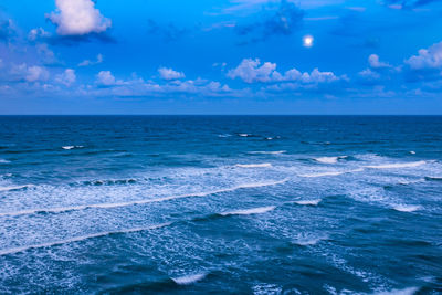 Scenic view of sea against blue sky