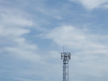 Low angle view of communications tower against sky