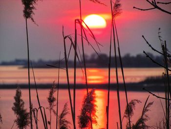 Scenic view of lake against romantic sky at sunset