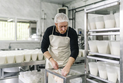 Male chef working in dairy factory