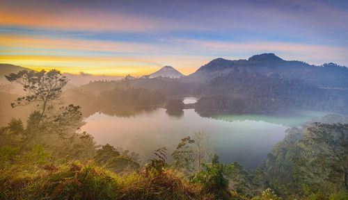 Scenic view of lake against sky during sunset