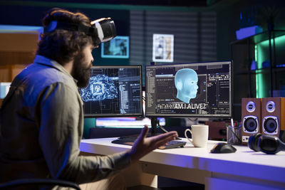 Rear view of man working in office