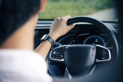 Rear view of man driving car