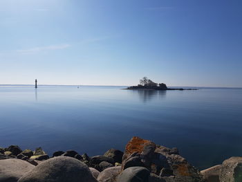 Scenic view of sea against clear blue sky