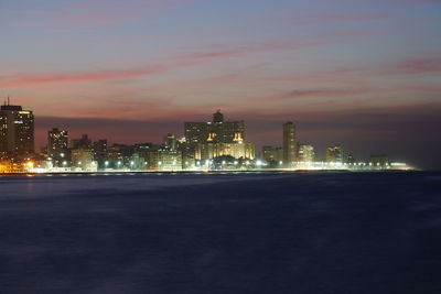 Illuminated buildings in city at night