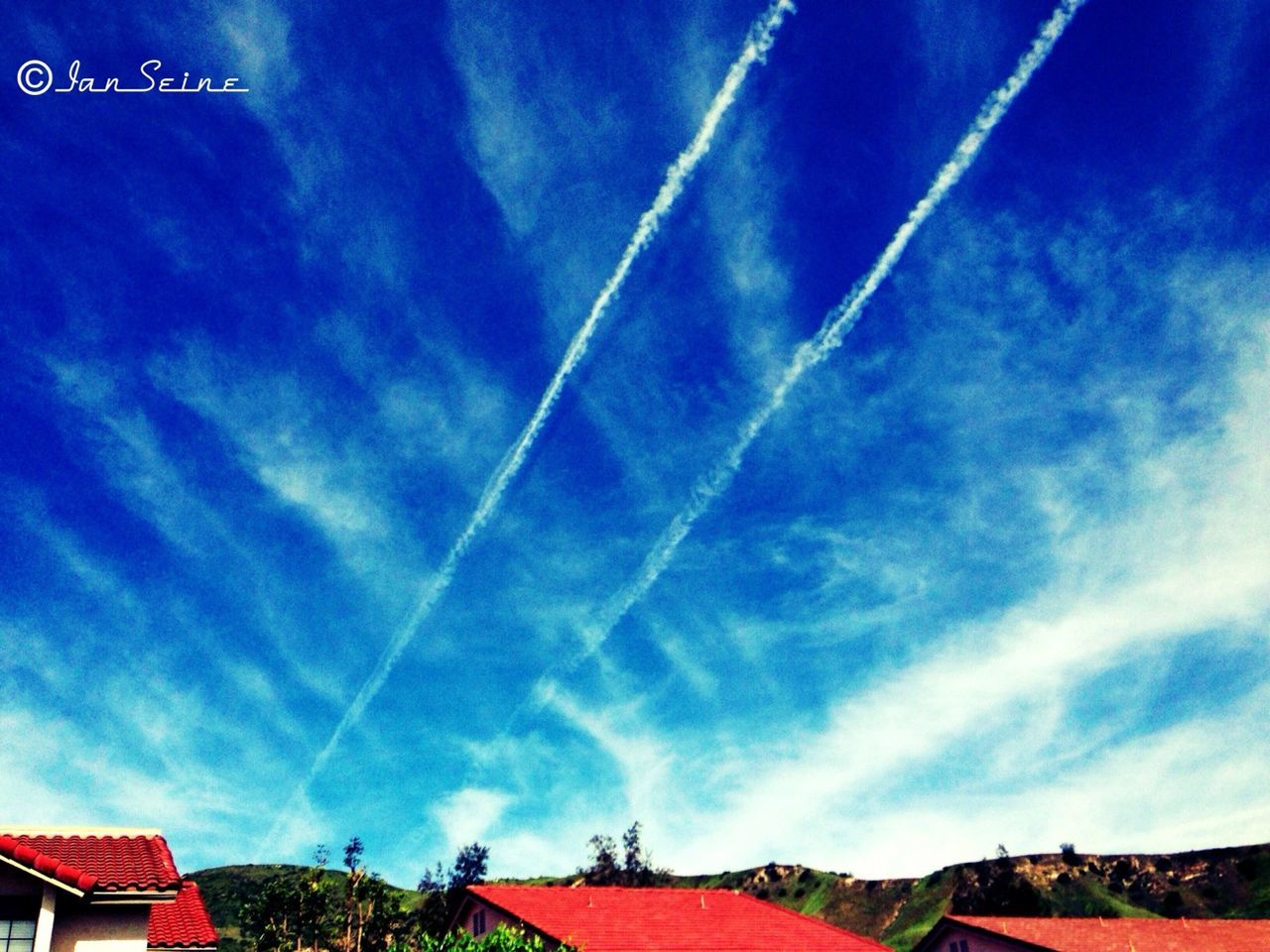 sky, blue, built structure, building exterior, architecture, cloud - sky, house, low angle view, cloud, cloudy, roof, residential structure, outdoors, no people, day, nature, town, multi colored, rainbow, beauty in nature