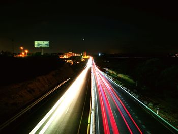 High angle view of light trails on highway at night