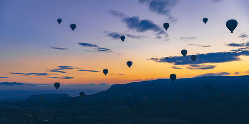 Hot air balloons fly at sunrise over the city of goreme in turkey.