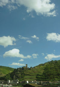 Scenic view of trees and buildings against sky