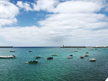 Boats in sea against sky