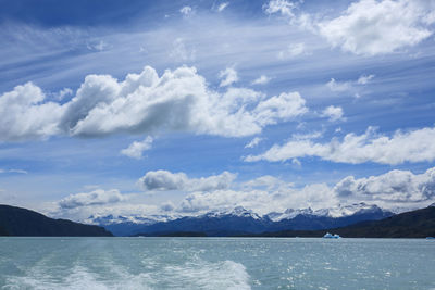 Scenic view of sea and mountains against sky