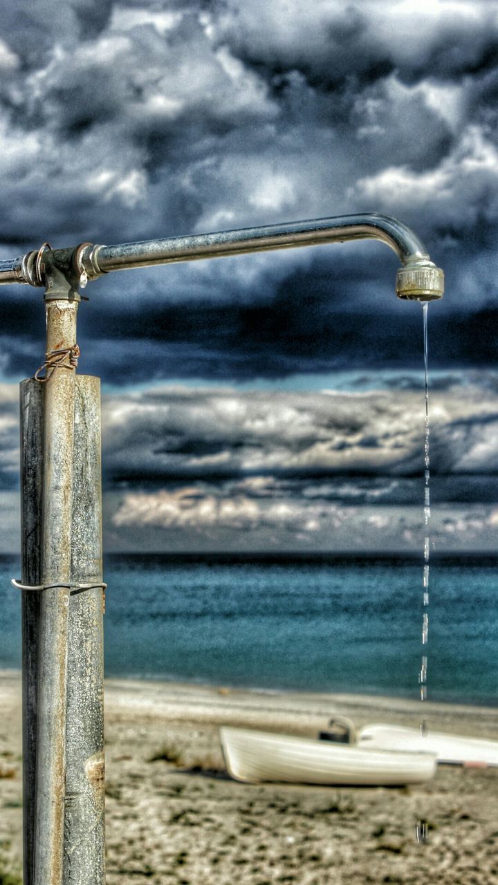 sky, cloud - sky, sea, cloudy, water, cloud, horizon over water, beach, weather, tranquility, scenics, nature, overcast, tranquil scene, beauty in nature, outdoors, day, shore, metal, rope